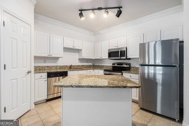 1850 Cotillion Dr Unit 4218, Atlanta, GA 30338 - kitchen with appliances with stainless steel finishes, light tile patterned floors, white cabinetry, and ornamental molding