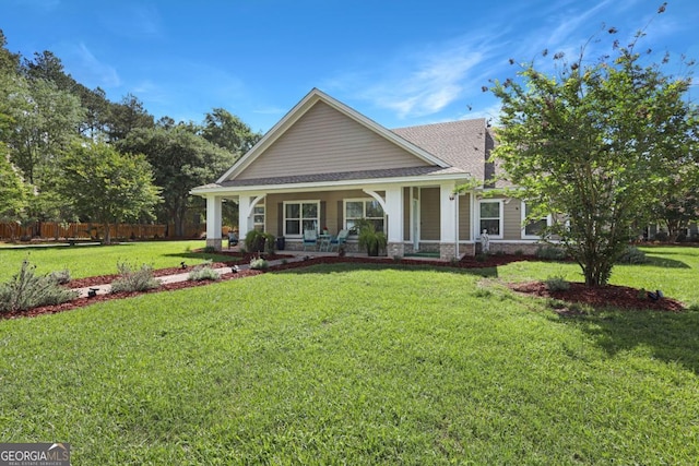 156 Hannah Dr, Jesup, GA 31546 - view of front of house featuring a porch, a shingled roof, and stone siding
