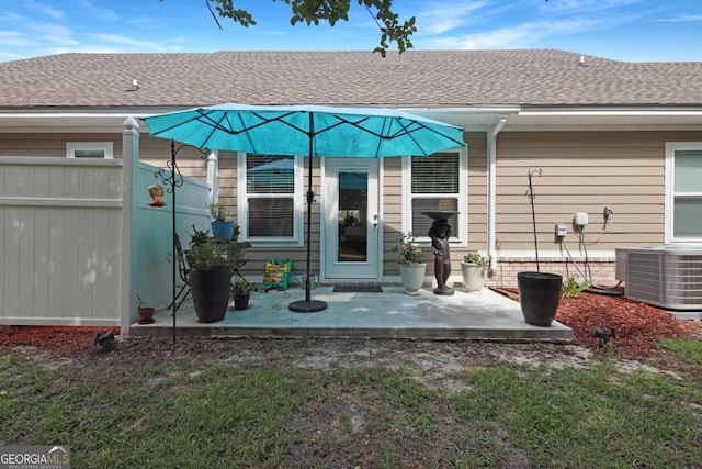 156 Hannah Dr, Jesup, GA 31546 - back of property featuring central AC, roof with shingles, and a patio
