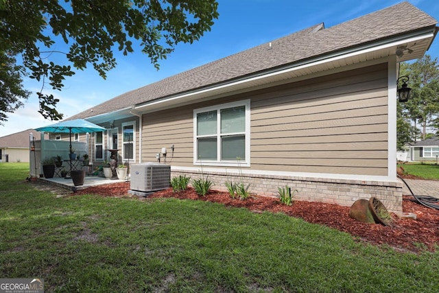 156 Hannah Dr, Jesup, GA 31546 - back of property featuring a patio area, a lawn, and a shingled roof