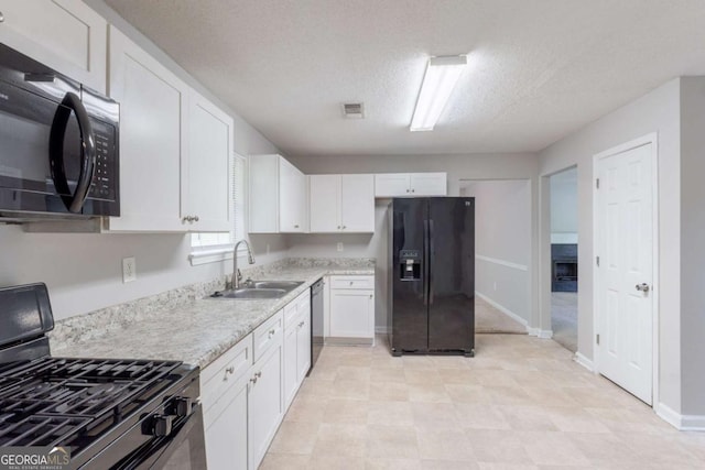 3075 Oakvale Hts, Decatur, GA 30034 - kitchen with black appliances, white cabinetry, and a textured ceiling