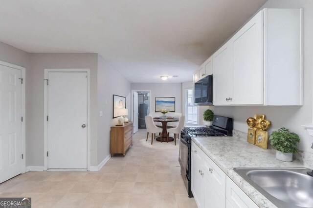3075 Oakvale Hts, Decatur, GA 30034 - kitchen featuring black appliances, a sink, white cabinetry, a textured ceiling, and baseboards