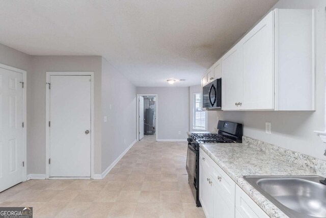 3075 Oakvale Hts, Decatur, GA 30034 - kitchen with black appliances, a sink, light countertops, and white cabinets