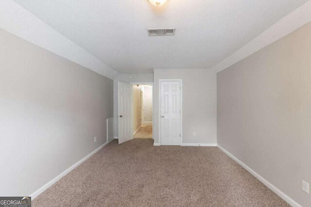 3075 Oakvale Hts, Decatur, GA 30034 - carpeted spare room featuring baseboards, a textured ceiling, and vaulted ceiling