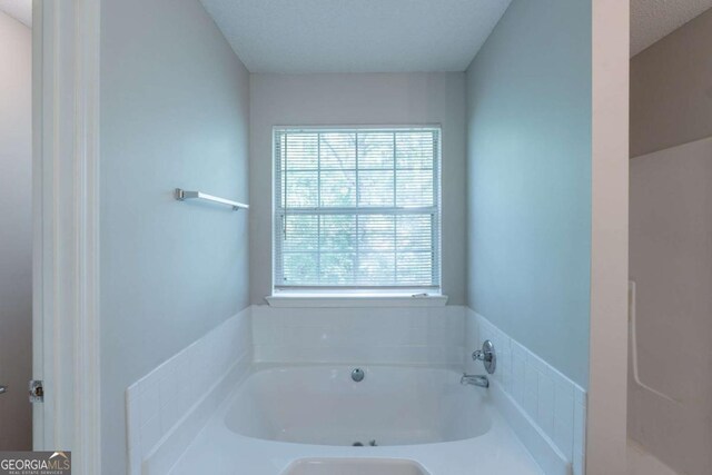 3075 Oakvale Hts, Decatur, GA 30034 - full bath with a textured ceiling, double vanity, baseboards, a garden tub, and tile patterned flooring