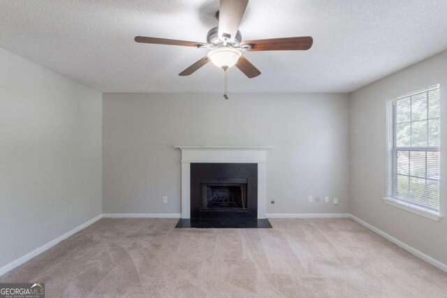 3075 Oakvale Hts, Decatur, GA 30034 - unfurnished living room with carpet, a fireplace with flush hearth, ceiling fan, a textured ceiling, and baseboards