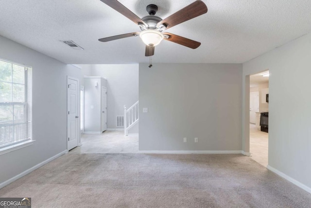 3075 Oakvale Hts, Decatur, GA 30034 - spare room featuring carpet, ceiling fan, stairway, and a textured ceiling