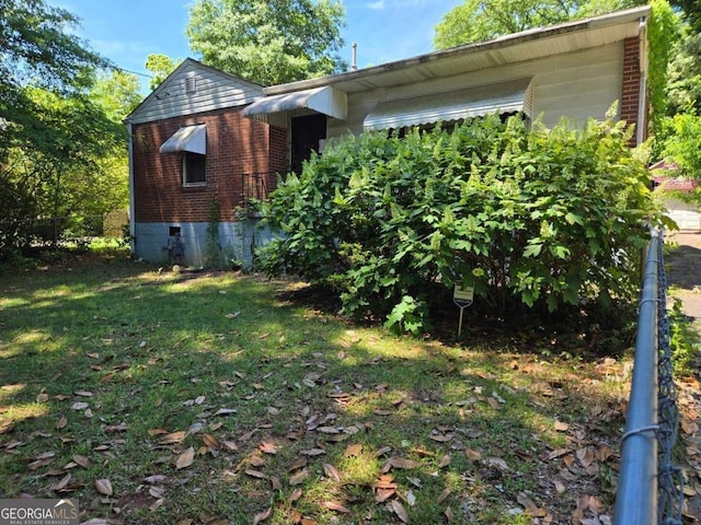 25 Candler Rd SE, Atlanta, GA 30317 - view of property exterior with brick siding and a yard