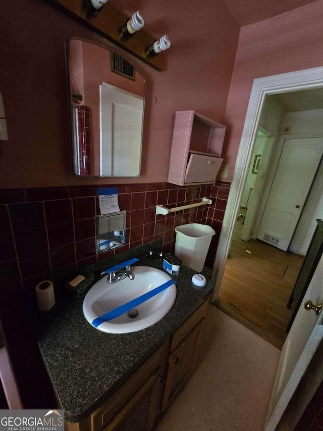 25 Candler Rd SE, Atlanta, GA 30317 - bathroom with tile walls, wainscoting, and vanity