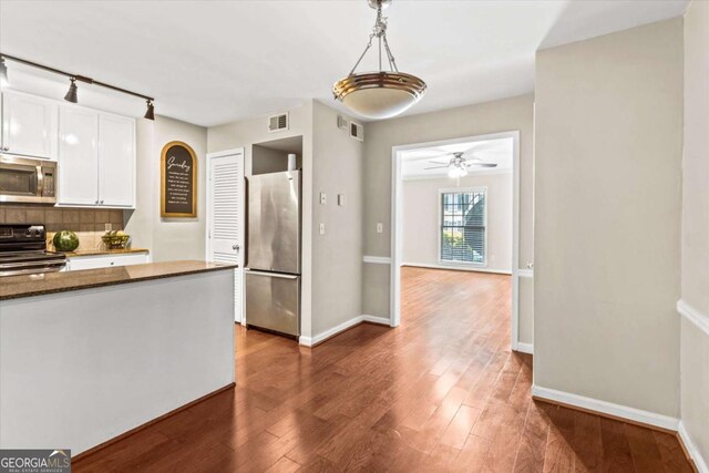 1101 Collier Rd NW Unit K2, Atlanta, GA 30318 - kitchen featuring appliances with stainless steel finishes, dark wood-type flooring, white cabinetry, baseboards, and decorative light fixtures