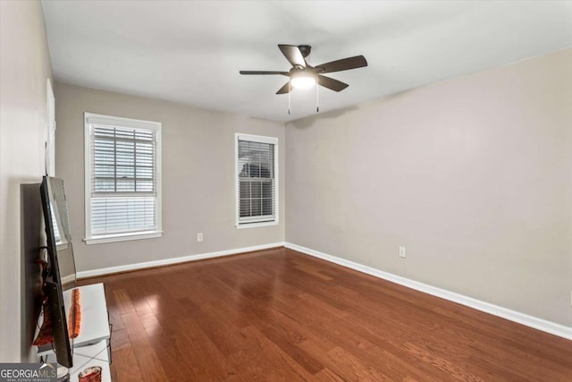 1101 Collier Rd NW Unit K2, Atlanta, GA 30318 - unfurnished living room with a ceiling fan, wood finished floors, and baseboards
