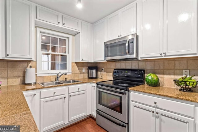 1101 Collier Rd NW Unit K2, Atlanta, GA 30318 - kitchen with dishwasher, a peninsula, a sink, white cabinetry, and dark wood-style floors
