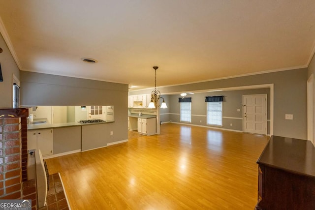 675 Mountain View Dr, Thomaston, GA 30286 - unfurnished living room with light wood-style floors and ornamental molding