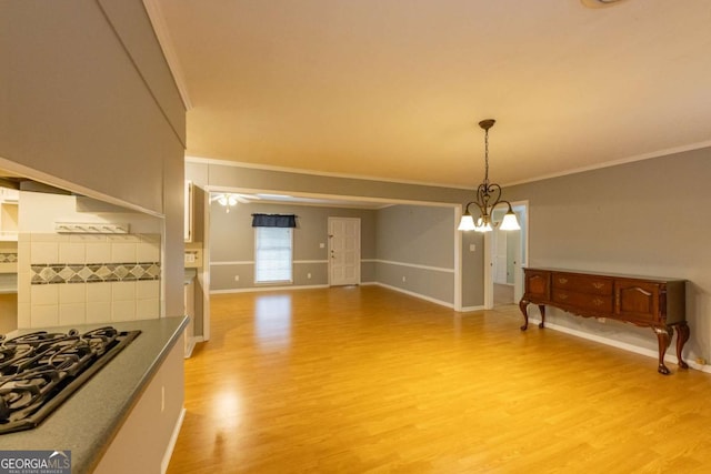 675 Mountain View Dr, Thomaston, GA 30286 - unfurnished dining area with light wood-style floors, ornamental molding, and a chandelier