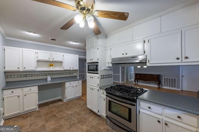 675 Mountain View Dr, Thomaston, GA 30286 - kitchen with stainless steel appliances, under cabinet range hood, open shelves, ornamental molding, and ceiling fan