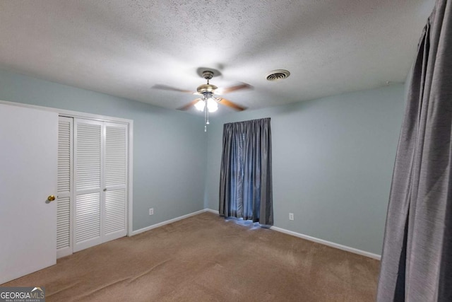 675 Mountain View Dr, Thomaston, GA 30286 - unfurnished bedroom with carpet flooring, a closet, a textured ceiling, and ceiling fan