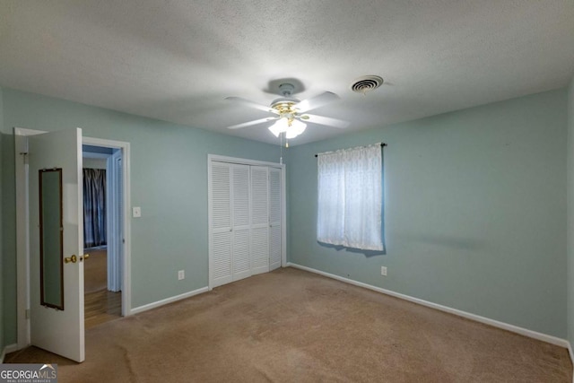 675 Mountain View Dr, Thomaston, GA 30286 - unfurnished bedroom featuring carpet floors, a closet, a ceiling fan, and a textured ceiling