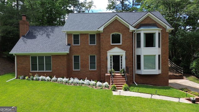 10310 Amberside Ct, Roswell, GA 30076 - colonial inspired home featuring a chimney, a front lawn, brick siding, and roof with shingles