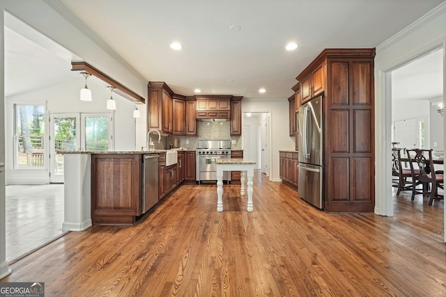 10310 Amberside Ct, Roswell, GA 30076 - kitchen with appliances with stainless steel finishes, light stone countertops, dark wood-style flooring, decorative backsplash, and a breakfast bar area