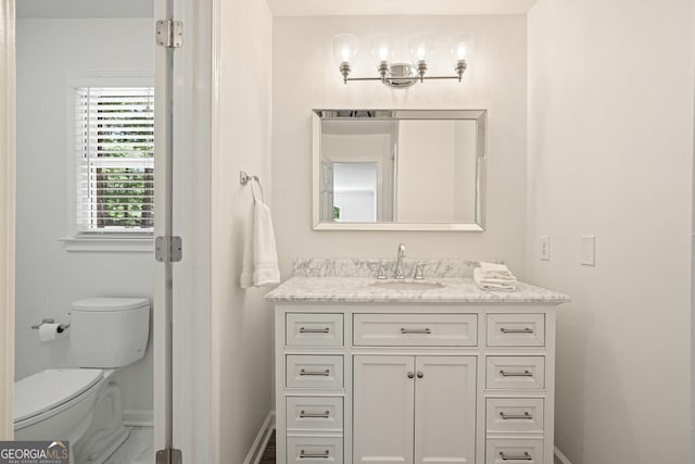 10310 Amberside Ct, Roswell, GA 30076 - bathroom featuring vanity, baseboards, and toilet