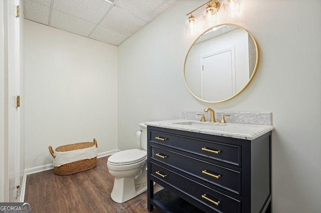 10310 Amberside Ct, Roswell, GA 30076 - bathroom with a drop ceiling, vanity, toilet, wood finished floors, and baseboards