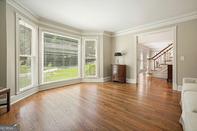 10310 Amberside Ct, Roswell, GA 30076 - unfurnished living room featuring healthy amount of natural light, crown molding, and wood finished floors