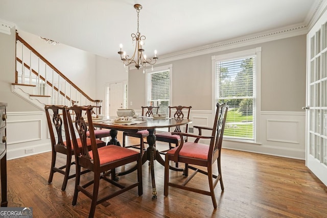 10310 Amberside Ct, Roswell, GA 30076 - dining area with a decorative wall, crown molding, wood finished floors, stairway, and a chandelier