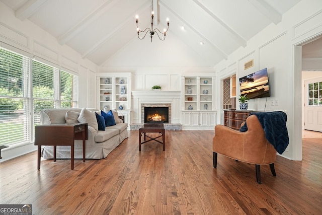 10310 Amberside Ct, Roswell, GA 30076 - living area with a chandelier, wood finished floors, built in features, a fireplace, and a decorative wall