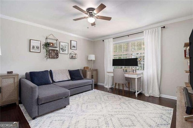 living area with a ceiling fan, wood finished floors, baseboards, and ornamental molding