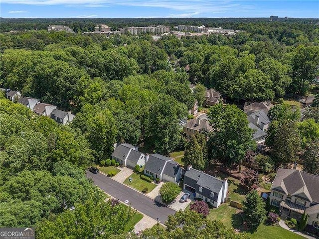 aerial perspective of suburban area with a heavily wooded area