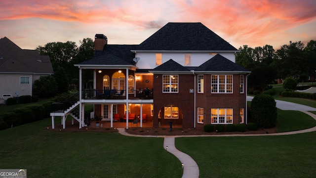 150 Bay Dr, Newnan, GA 30263 - back of property at dusk featuring a lawn, a patio area, stairs, and a chimney