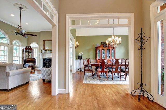 150 Bay Dr, Newnan, GA 30263 - dining area featuring a ceiling fan, light wood finished floors, crown molding, a chandelier, and baseboards