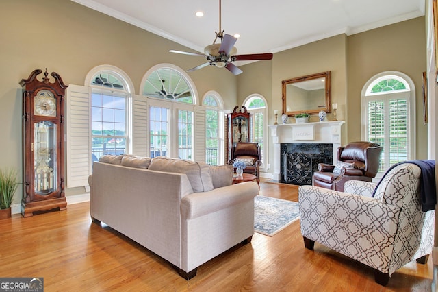 150 Bay Dr, Newnan, GA 30263 - living room with a fireplace, ceiling fan, recessed lighting, crown molding, and light wood finished floors