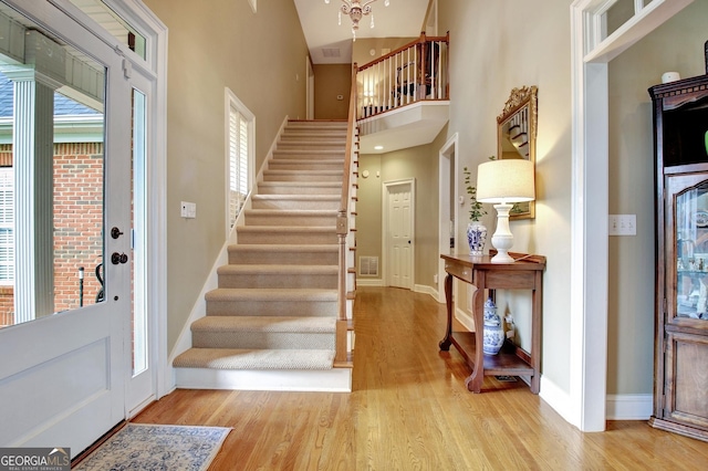 150 Bay Dr, Newnan, GA 30263 - foyer featuring stairway, wood finished floors, baseboards, and a high ceiling