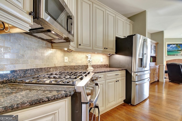 150 Bay Dr, Newnan, GA 30263 - kitchen featuring appliances with stainless steel finishes, light wood-type flooring, and cream cabinetry