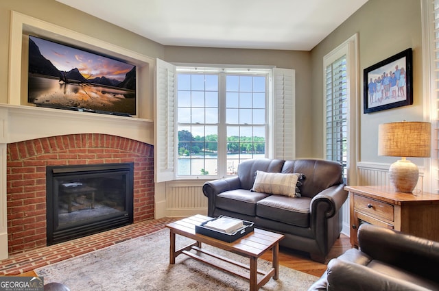 150 Bay Dr, Newnan, GA 30263 - living room featuring a brick fireplace and a wainscoted wall