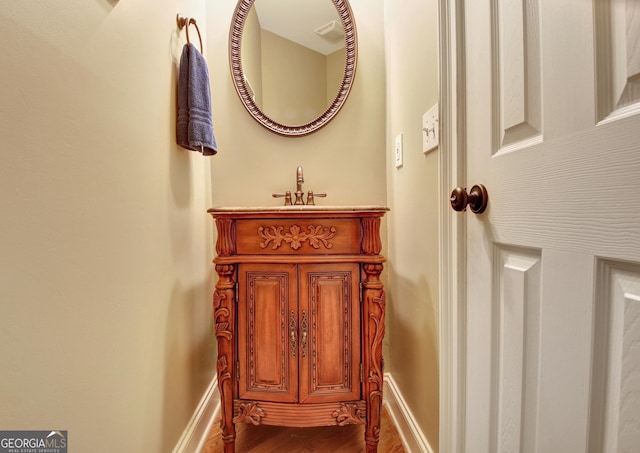 150 Bay Dr, Newnan, GA 30263 - bathroom featuring wood finished floors, baseboards, and a sink