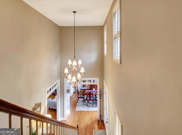150 Bay Dr, Newnan, GA 30263 - stairs featuring wood finished floors, a chandelier, and a high ceiling