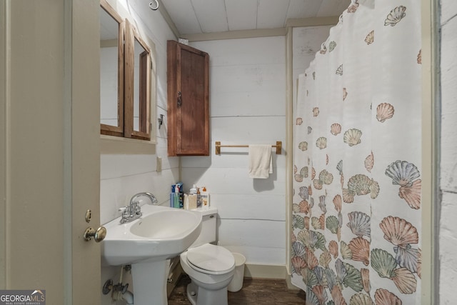 171 N Jefferson Ave, Talbotton, GA 31827 - bathroom with toilet, curtained shower, wood finished floors, and wooden walls