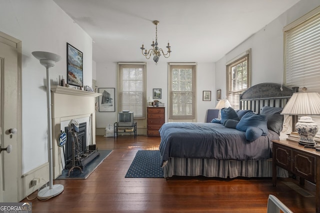 171 N Jefferson Ave, Talbotton, GA 31827 - bedroom featuring wood-type flooring, a chandelier, and a fireplace