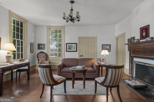 171 N Jefferson Ave, Talbotton, GA 31827 - living room with wood finished floors, a chandelier, and a fireplace with raised hearth