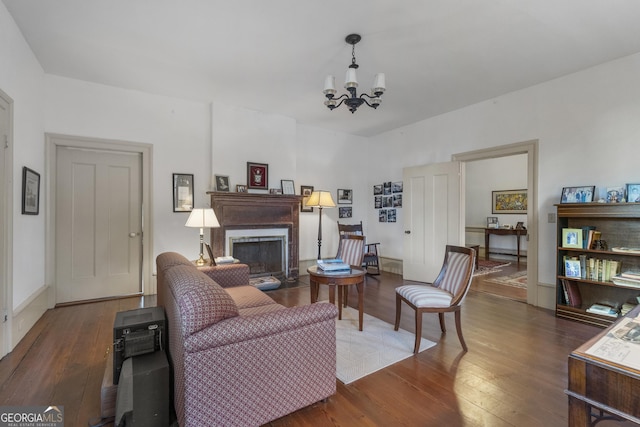 171 N Jefferson Ave, Talbotton, GA 31827 - living room featuring wood finished floors, a chandelier, and a fireplace