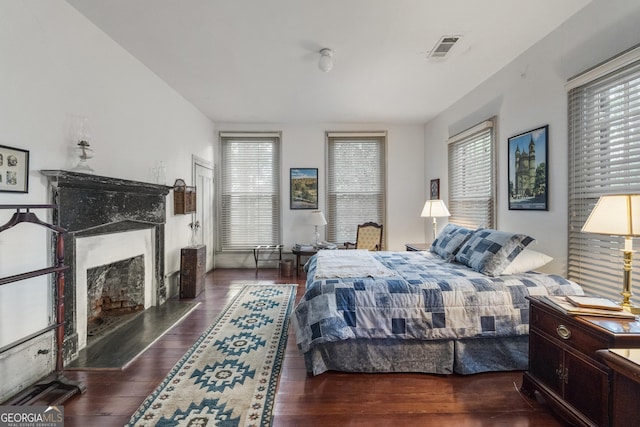 171 N Jefferson Ave, Talbotton, GA 31827 - bedroom featuring multiple windows, a premium fireplace, and wood finished floors