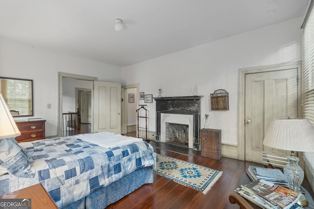 171 N Jefferson Ave, Talbotton, GA 31827 - bedroom with hardwood / wood-style flooring and a high end fireplace