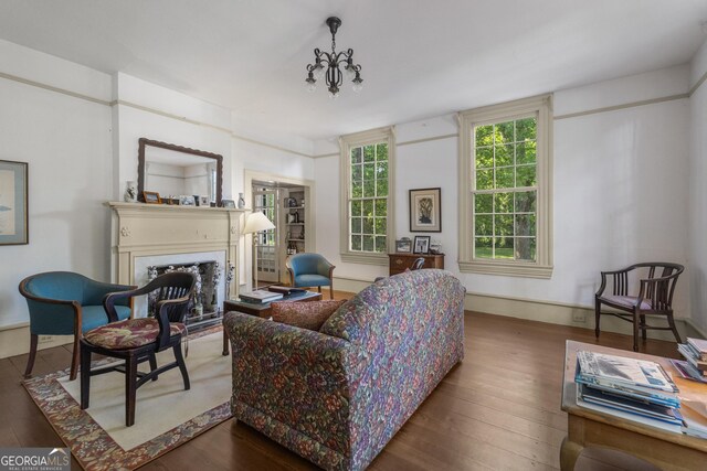 171 N Jefferson Ave, Talbotton, GA 31827 - living room featuring a fireplace, wood finished floors, and a chandelier