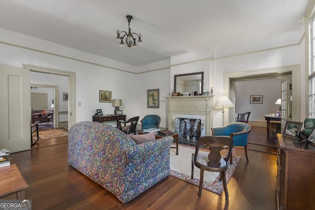 171 N Jefferson Ave, Talbotton, GA 31827 - living room with dark wood-style flooring, a fireplace with flush hearth, and a chandelier