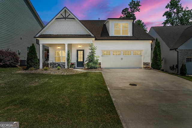 75 Georgian Oaks Ct, Newnan, GA 30265 - view of front of house with concrete driveway, a front yard, a porch, central AC, and a shingled roof