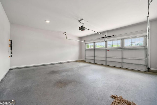 75 Georgian Oaks Ct, Newnan, GA 30265 - garage with a garage door opener and baseboards