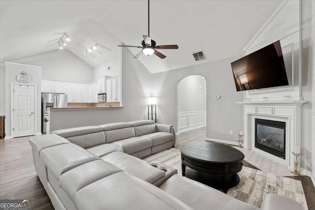 613 Wiley Ct, Canton, GA 30115 - living area with a ceiling fan, arched walkways, track lighting, wood finished floors, and a large fireplace
