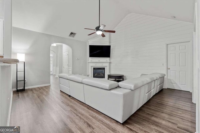 613 Wiley Ct, Canton, GA 30115 - living area with arched walkways, a ceiling fan, high vaulted ceiling, wood finished floors, and a glass covered fireplace